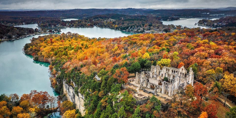 Ha Ha Tonka from the air in autumn: the castle ruins on a limestone bluff over the turquoise water of Lake of the Ozarks